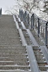 The stairs of the aboveground pedestrian bridge on a winter day