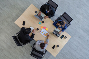 Business meeting top view of business people in formal wear sitting at the table and discussion