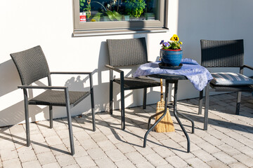 Chairs and table for relaxing outdoors on the terrace, veranda. Comfort relaxing zone. Cozy and comfortable atmosphere. Sunny day.