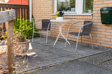 Chairs and table for relaxing outdoors on the terrace, veranda. Comfort relaxing zone. Cozy and comfortable atmosphere. Sunny day.