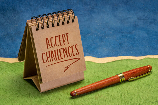 accept challenges motivational note or reminder in a small desktop calendar, personal development concept