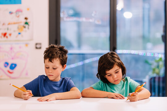 Siblings drawing at home together