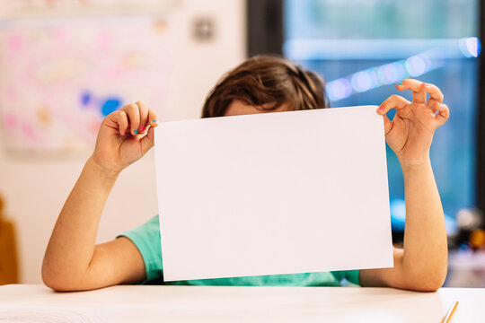 Anonymous girl showing blank paper