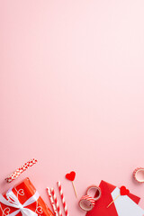 Valentine's Day concept. Top view vertical photo of red giftbox straws decorative tape paper heart and envelope with letter on isolated pastel pink background with blank space