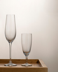 two wine glasses on a wooden table 