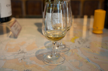 Tasting of white dry chablis wine in small winery in Chablis town, Burgundy, France