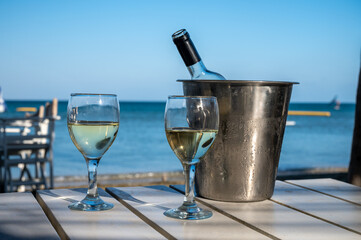 Drinking of cold white wine in beach bar, summer holidays, relax on sandy beach