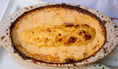 Quenelle, speciality of Lyon, oval-shaped dumplings filled with pike white fish served in creamy sauce in traditional Lyonnaise Bouchon, France