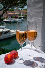 Summer party, drinking of French brut champagne sparkling wine in glasses in yacht harbour of Port Grimaud near Saint-Tropez, French Riviera vacation, France