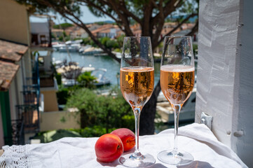 Summer party, drinking of French brut champagne sparkling wine in glasses in yacht harbour of Port Grimaud near Saint-Tropez, French Riviera vacation, France