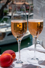 Summer party, drinking of French brut champagne sparkling wine in glasses in yacht harbour of Port Grimaud near Saint-Tropez, French Riviera vacation, France