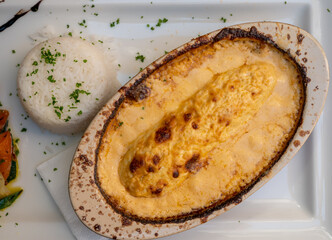 Quenelle, speciality of Lyon, oval-shaped dumplings filled with pike white fish served in creamy...