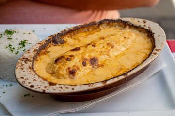 Quenelle, speciality of Lyon, oval-shaped dumplings filled with pike white fish served in creamy sauce in traditional Lyonnaise Bouchon, France