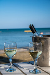 Drinking of cold white wine in beach bar, summer holidays, relax on sandy beach