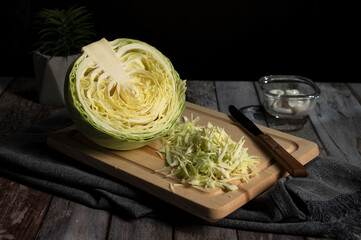 Sliced cabbage lies on the table in the kitchen 

