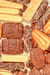 Close up of delicious bisquits and chocolate. Bisquits on plate top view, cookies on wooden empty space wood background. Macro sweets