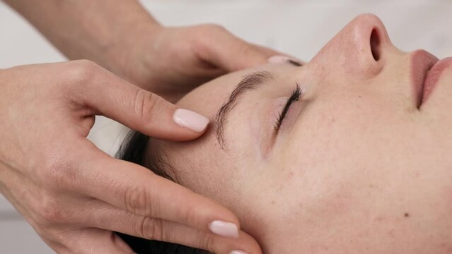 Spa, wellness and women receiving head massage, facial and skin care.