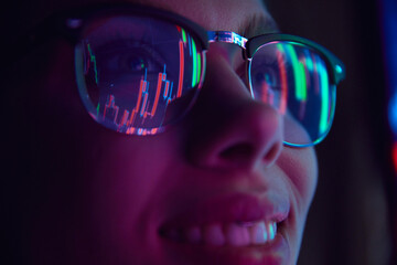 Close up view of girl's eyes in glasses looking at pc screen with computer reflection at eyewear....