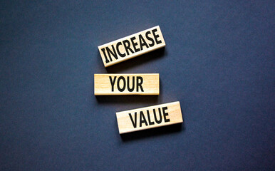 Increase your value symbol. Concept words Increase your value on wooden blocks on a beautiful black table black background. Business increase your value concept. Copy space.