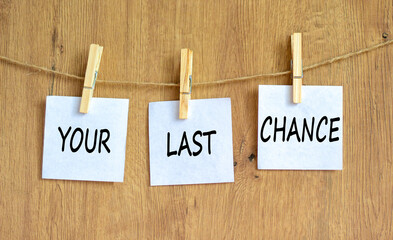 Time to your last chance symbol. Concept words Your last chance on white paper on a beautiful...