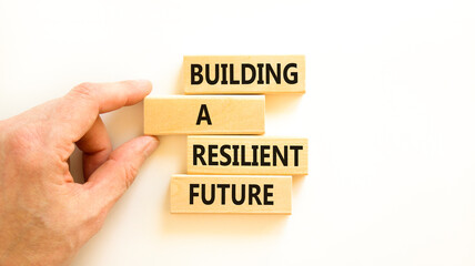 Building a resilient future symbol. Concept word Building a resilient future on wooden blocks. Beautiful white table white background. Business and building a resilient future concept. Copy space.