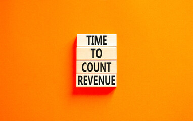 Time to count revenue symbol. Concept word Time to count revenue on wooden blocks. Beautiful orange table orange background. Business and time to count revenue concept. Copy space.
