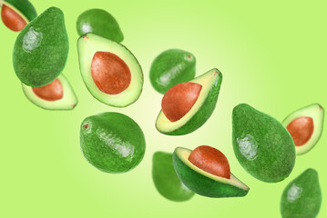 Levitation of avocados on a green background.