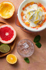 Fototapeta na wymiar citrus juicer, sliced fruit, glass with ice, close-up, no people, breakfast,