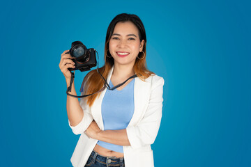 Fototapeta premium Beautiful woman holding a camera and taking pictures