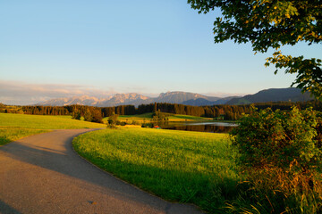 hiking trail overlooking scenic alpine lake Attlesee and the lush alpine valley with its endless green alpine meadows in the Bavarian Alps in Nesselwang, Allgaeu or Allgau, Bavaria, Germany	