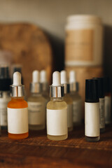 Mock-up of facial serums on a wooden stand. Natural cosmetic products. Copy space. Vertical