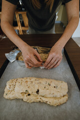 Female hands making foil border for raw stollen.