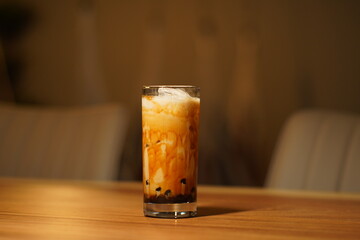 A cold cappuccino in a glass.