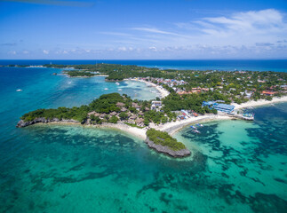 Sunny Day in Malapascua Island in Visayan Sea, One of Cebu Island. Sea water and Boats. Bounty Beach with Local Architecture