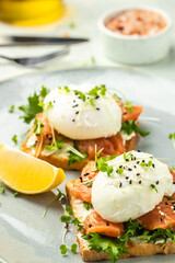 Poached egg with salmon and guacamole on toast. Delicious breakfast. Food recipe background. Close up