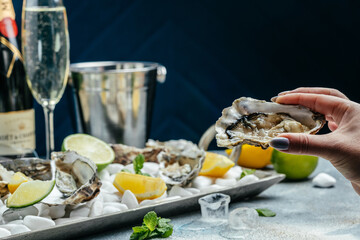Fresh oysters on ice with lemon. Healthy food, gourmet food. Oyster dinner in restaurant