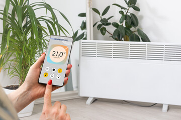 Smart heater convector control by phone app. Smart Home with the smart heating system. Electric...