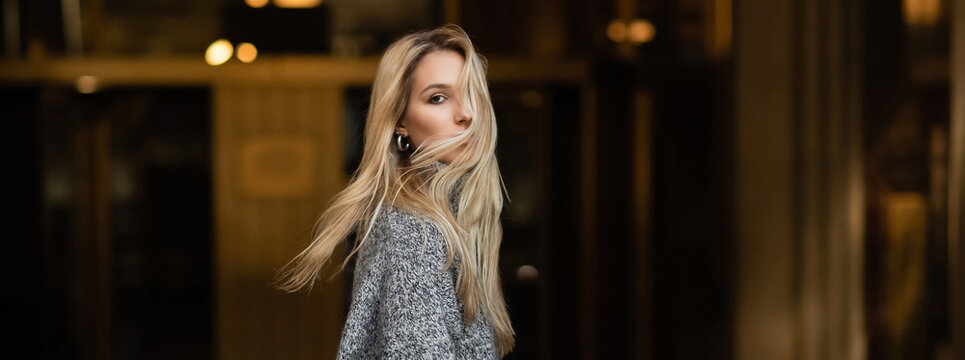 Young And Stylish Woman In Grey Sweater Looking At Camera In New York, Banner