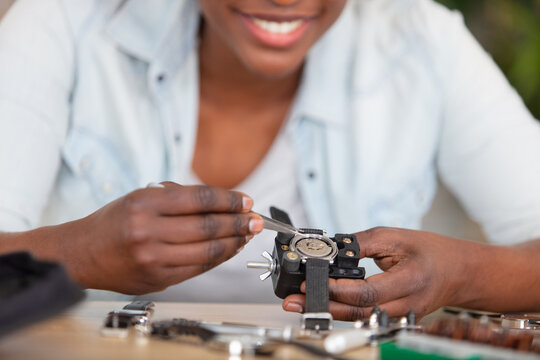 cropped image of woman repairing a wristwatch - Powered by Adobe
