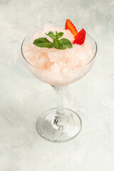 Frose cocktail mixed with strawberriess with pink wine. Alcoholic Beverage. Boozy Frozen Rose Frose