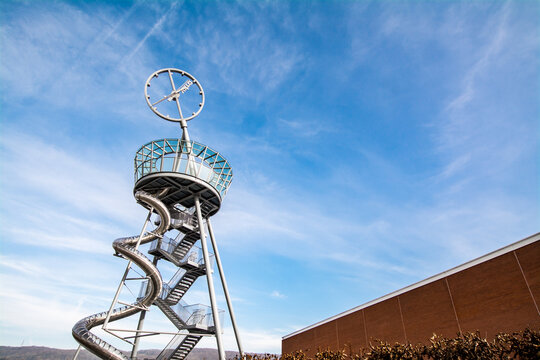 Vitra Tour-Toboggan (Vitra Slide Tower) in Vitra Design Museum Campus by artist Carsten H&ouml;ller. It consists of three diagonal columns with a clock at the top in WEIL AM RHEIN, GERMANY on JAN 27, 2017