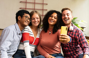Fototapeta premium Young friends group making selfie with smartphone - Community concept with multicultural and multiethnic friends having fun video calling with friends - Diversity and friendship concept