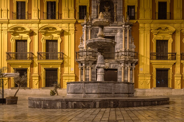 Amazing night photography around Malaga La Manquita Cathedral, Plaza de la Constitucion and Marques de Larios street in long time exposure. Malaga old city center empty streets at night. Spain