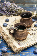 The concept of rustic style tea. Lavender flowers and blueberries. Vintage book