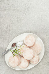 Chunks of frozen hake. Marine fish fillet on stone background, raw ingredient for cooking food