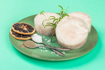 Chunks of frozen hake. Marine fish fillet on stone background, raw ingredient for cooking food