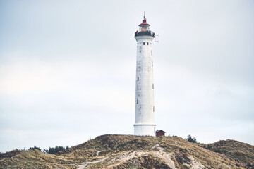 Lighthouse Lyngvig Fyr at danish west coast in winter. High quality photo - obrazy, fototapety, plakaty