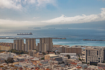 View from the Rock of Gibraltar to the bay of Gibraltar full of ships on the roadstead and The Port of Algeciras. Incredible skyline, blue sky with amazing clouds. Gibraltar, UK