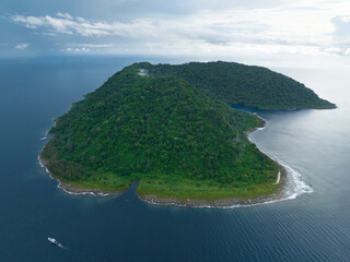 Rainforest covers the remote Mary Island which is fringed by a coral reef in the Solomon Islands....