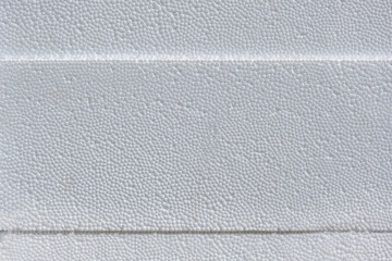 Konzept Wärmedämmung mit Styropor: Extreme Nahaufnahme von drei aufeinanderliegenden weißen...